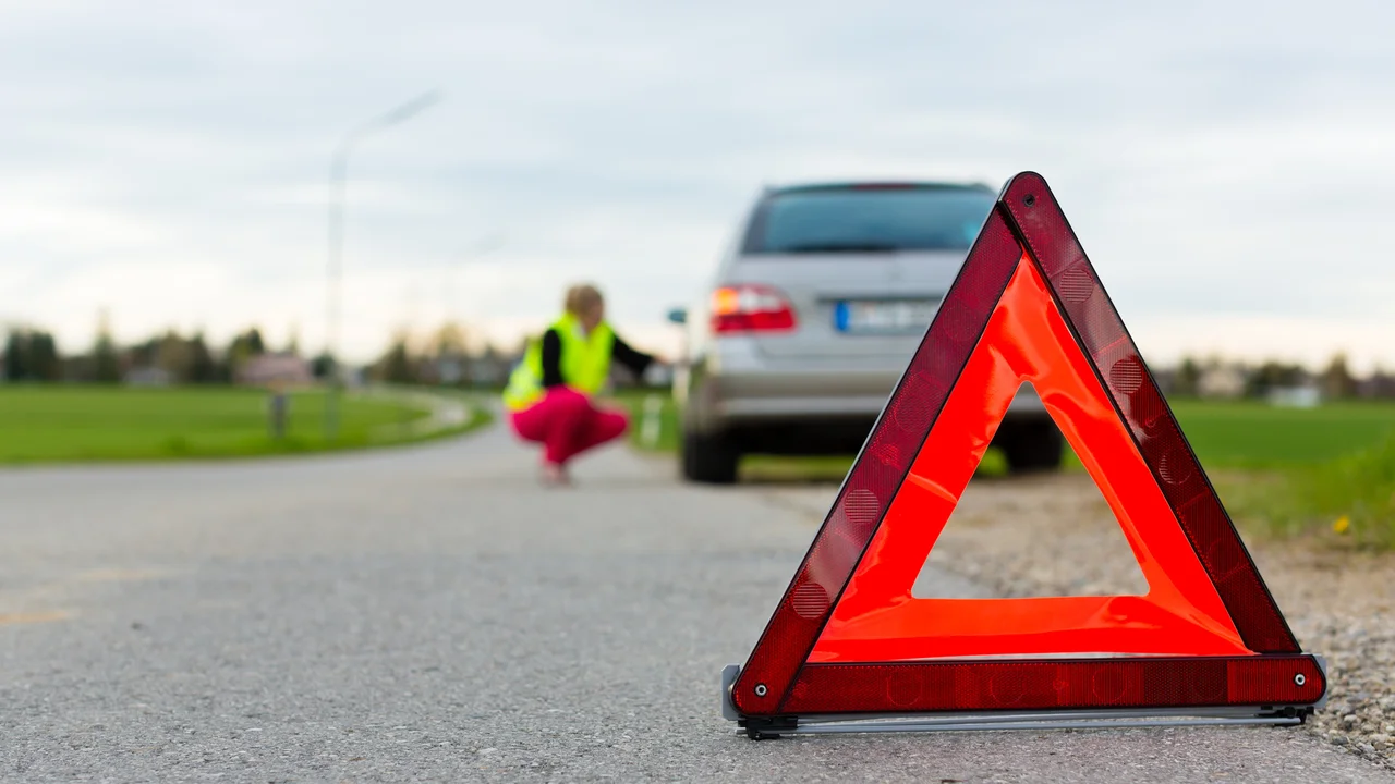 blue bowl of black bean beef tortilla soup on a board with cilantro and shredded cheese in background