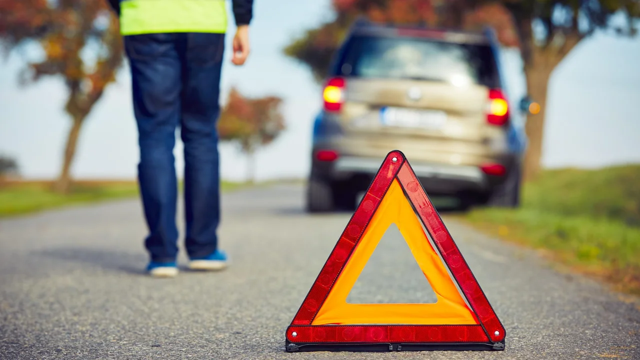 blue bowl of black bean beef tortilla soup on a board with cilantro and shredded cheese in background