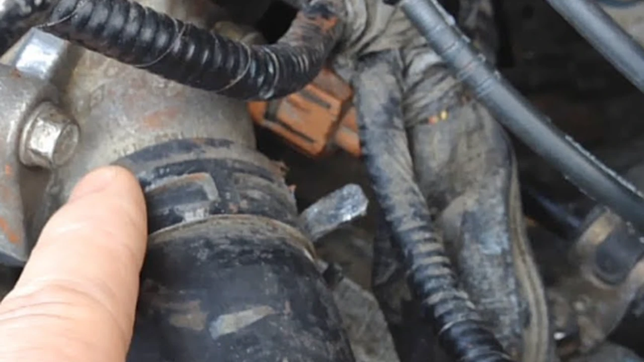 Close up on a plate of mashed potatoes, topped with baked pork chops with cream of mushroom soup, and a side of green beans.